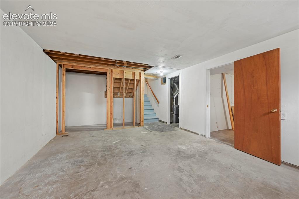 Image 39 of 50: Basement Family Room (Looking Towards Bedroom, Mechanical Room & Stairs)