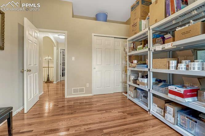 Image 21 of 48: Main level bedroom currently used for work storage