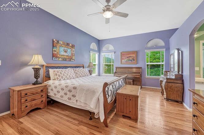 Image 26 of 48: Bedroom with wood floors and a ceiling fan