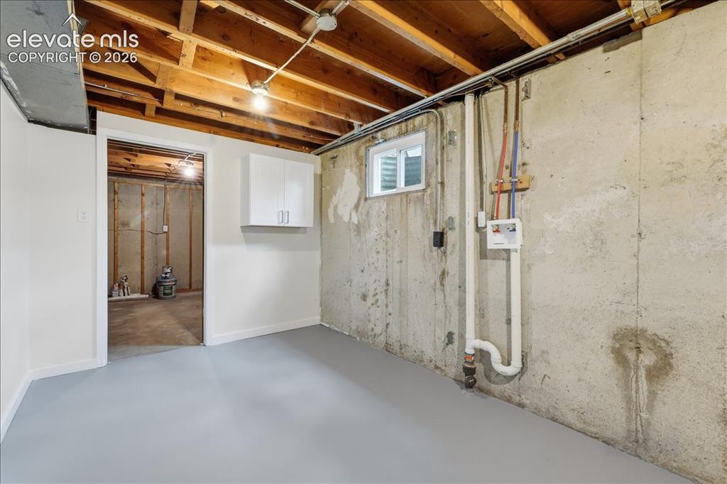 Image 29 of 44: Laundry area and huge storage room.