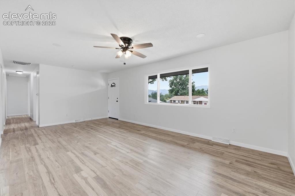 Image 7 of 44: Large living room. Brand new windows.