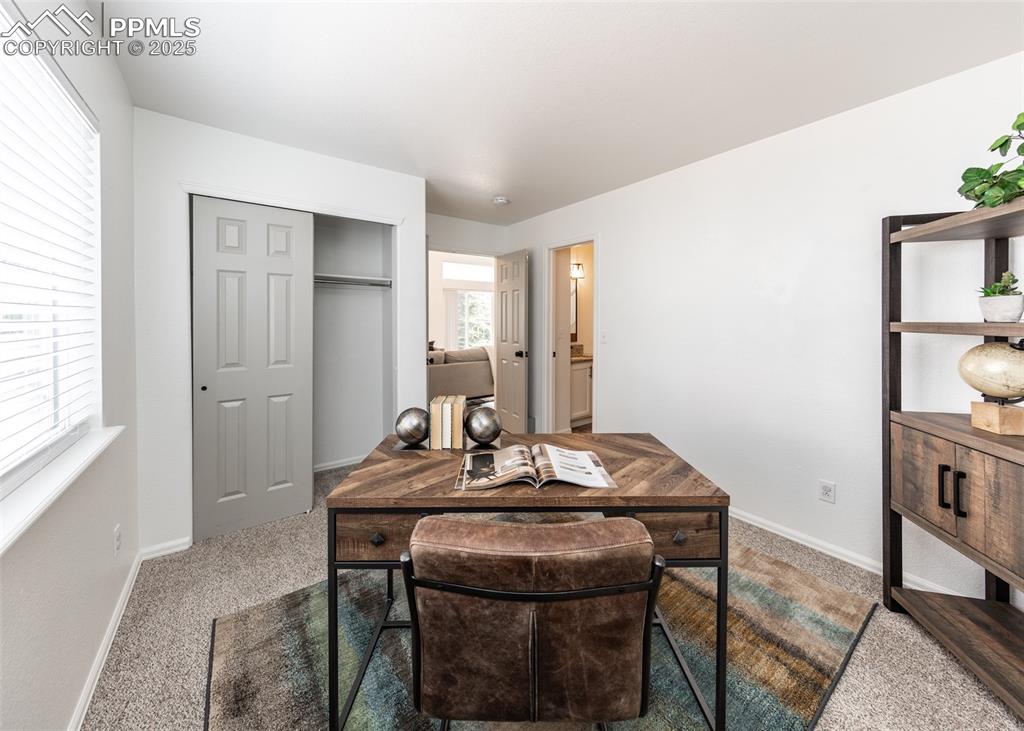 Image 23 of 50: Carpeted home office featuring baseboards