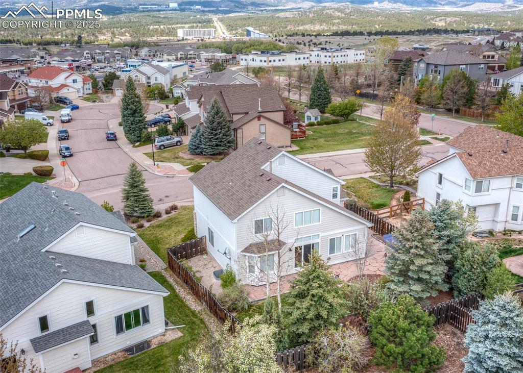 Image 3 of 50: Aerial view of residential area featuring a mountainous background