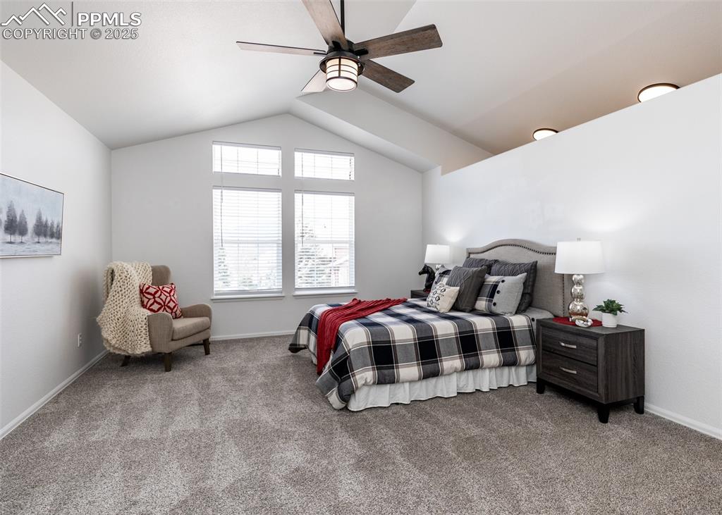 Image 30 of 50: Bedroom with carpet floors, lofted ceiling, ceiling fan, and baseboards