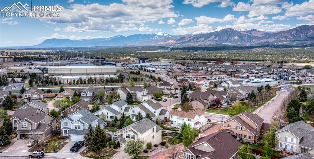 Image 4 of 50: Aerial view of residential area featuring a mountainous background