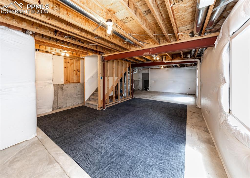 Image 44 of 50: Unfinished below grade area featuring stairs
