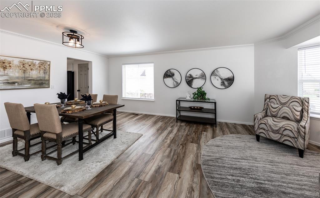 Image 8 of 50: Dining area featuring wood finished floors, healthy amount of natural light