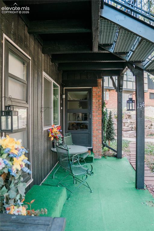 Image 10 of 23: Covered exterior entry with black siding