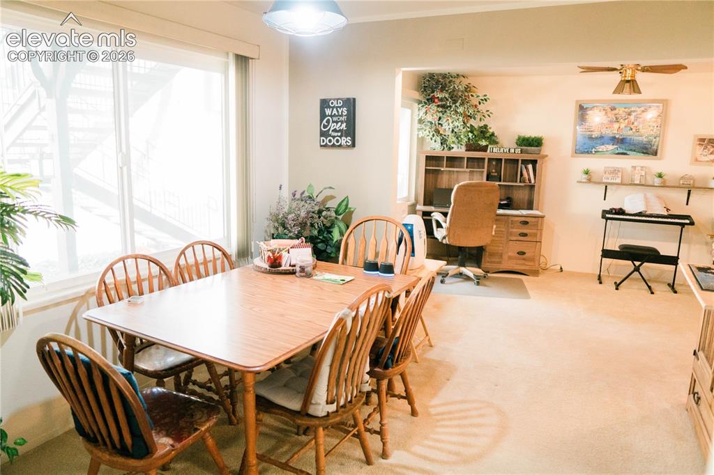 Image 19 of 23: Bright interior with large windows and a built-in office nook