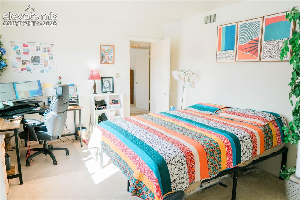 Image 6 of 23: Light-colored wall finishes, carpeted flooring, and a door frame