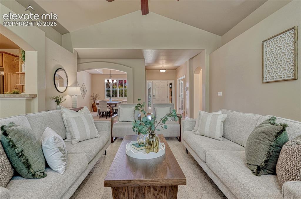 Image 10 of 42: Living room with vaulted ceiling...