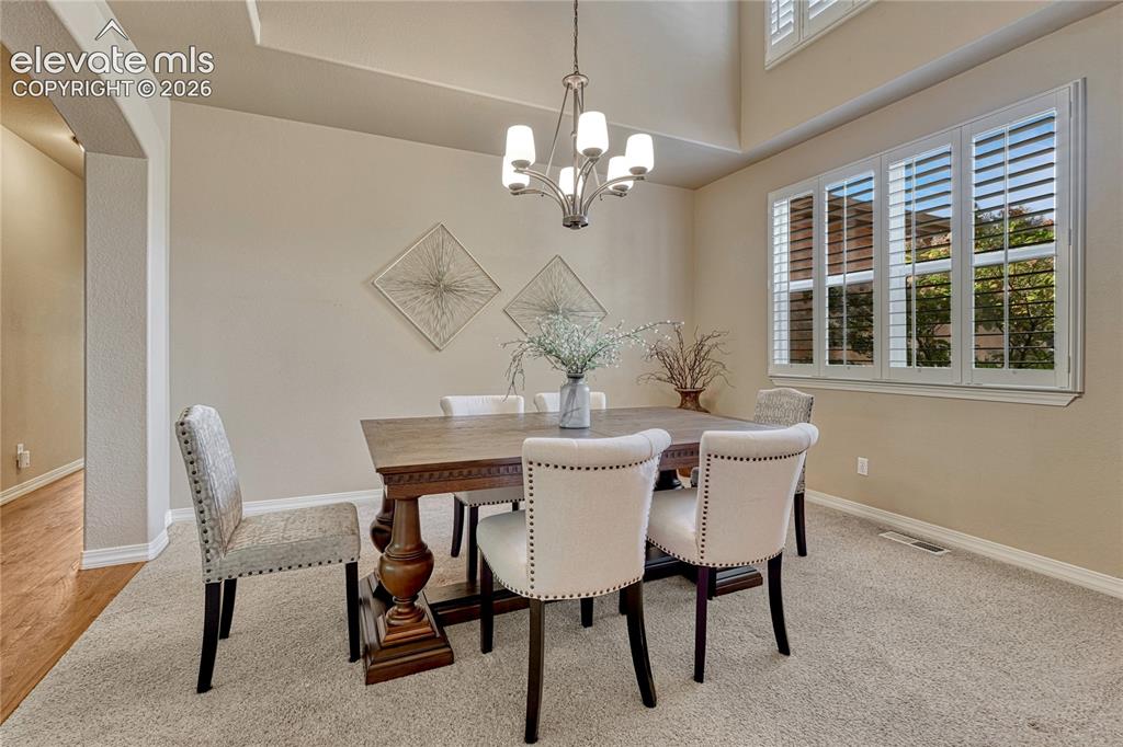 Image 6 of 42: Formal dining with plantation shutters...
