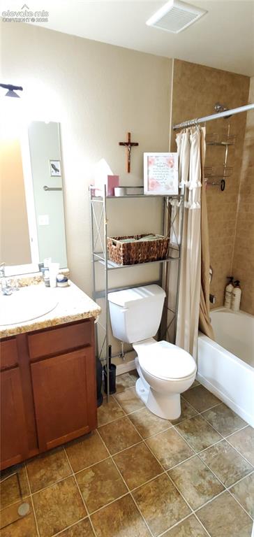 Image 13 of 20: Warm-toned tile flooring, single vanity with light-toned countertop, wood-f
