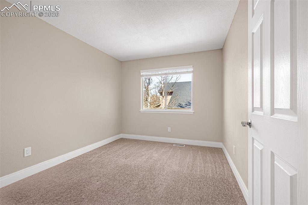 Image 13 of 28: Unfurnished room featuring light colored carpet and baseboards