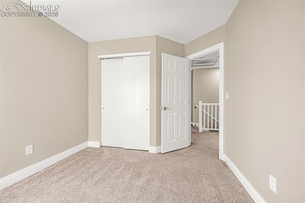 Image 15 of 28: Unfurnished bedroom with a closet and light carpet