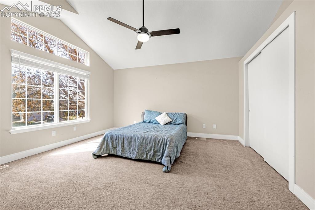 Image 17 of 28: Bedroom featuring carpet, a ceiling fan, a closet, and lofted ceiling