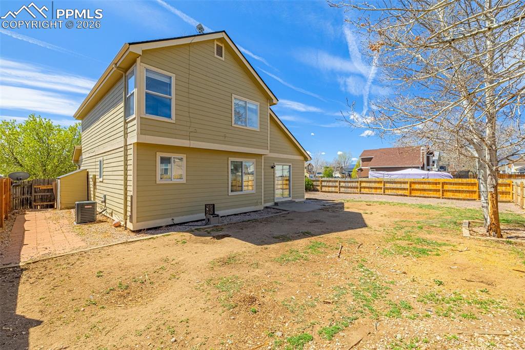 Image 27 of 28: Rear view of property with a fenced backyard