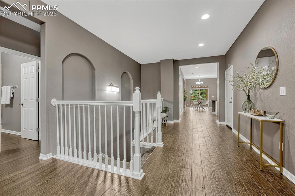 Image 10 of 50: Great curb appeal with low maintenance landscaping with trees, green grass,