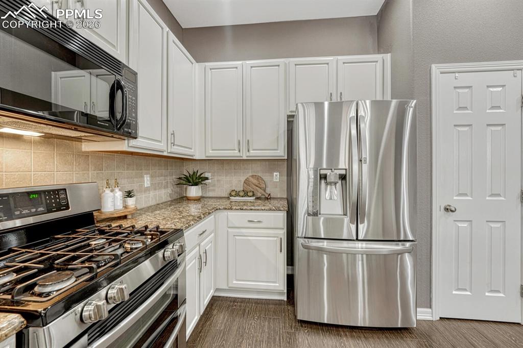 Image 13 of 50: Front Entry with stairs to the Finished Basement.