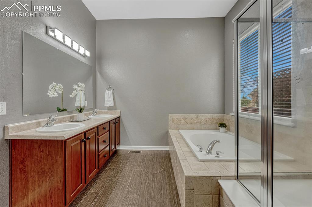 Image 19 of 50: The Great Room offers a wall of windows, lighted ceiling fan, built-ins, an