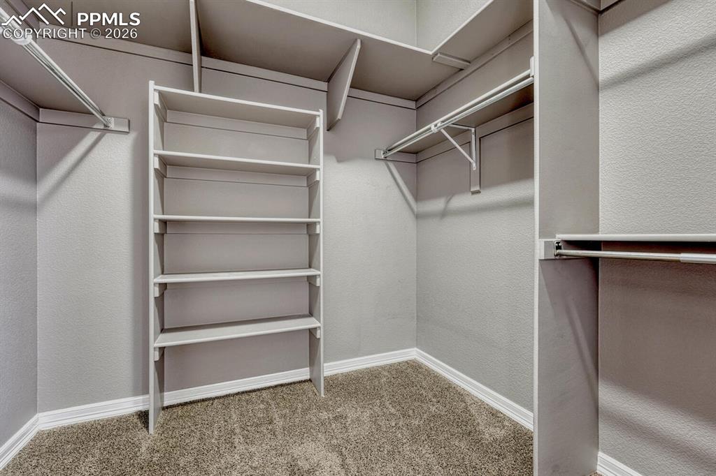 Image 22 of 50: The Primary Bathroom features a dual sink vanity, mirror, soaking tub, and 