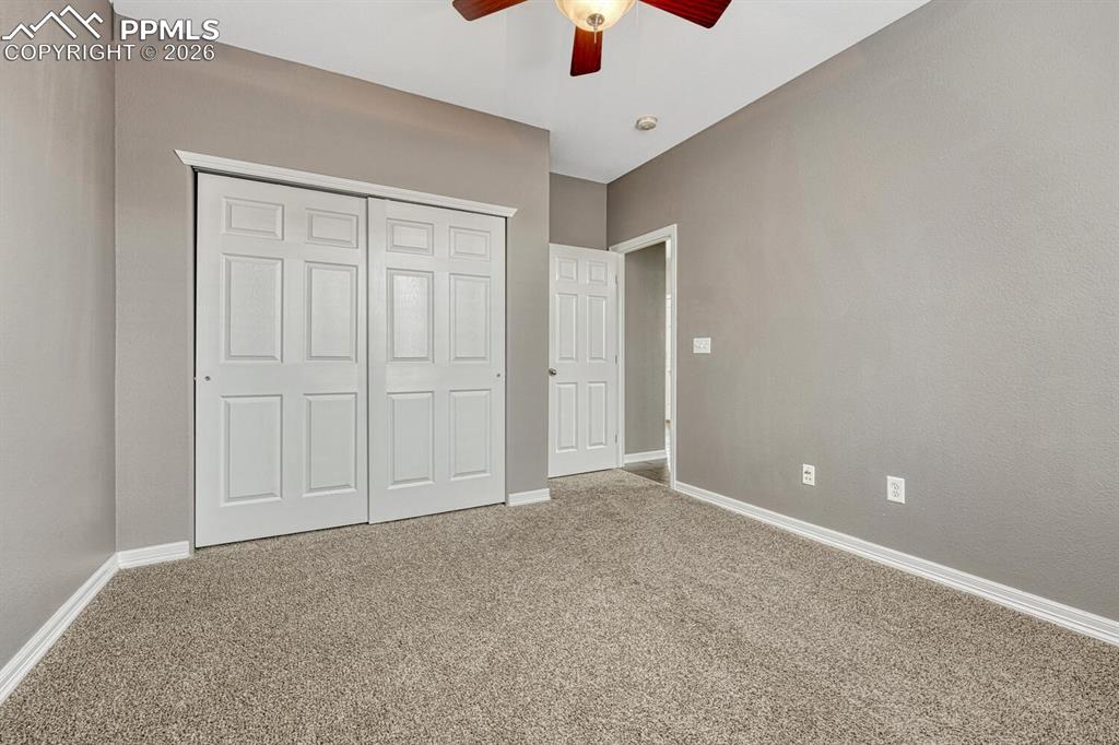 Image 27 of 50: Main Level Bedroom #2 with wall of windows and generous closet.