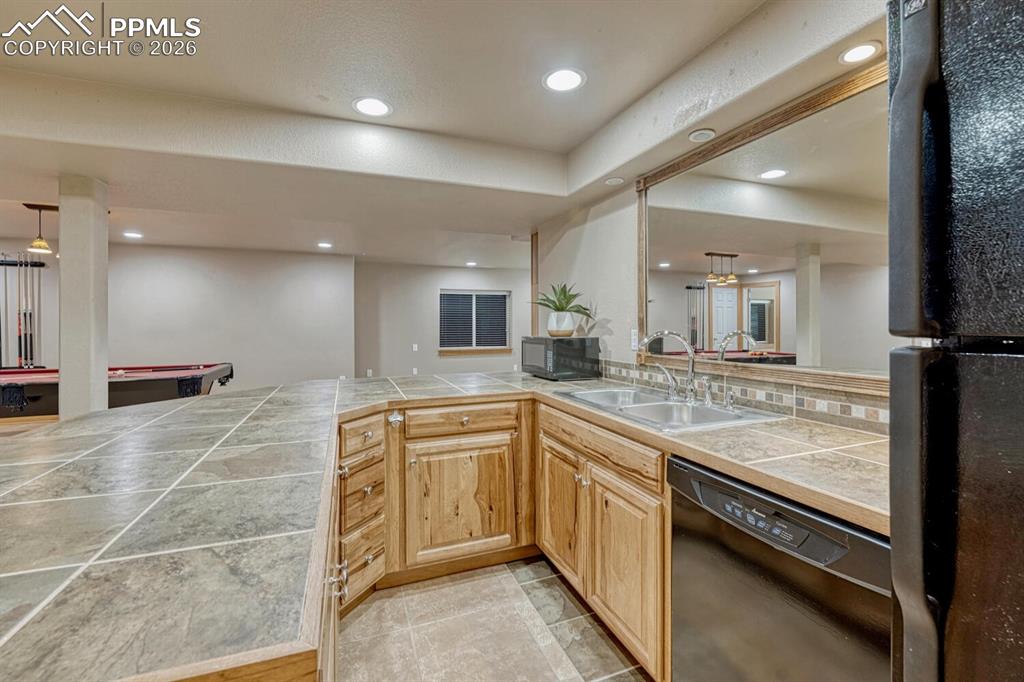 Image 33 of 50: Family Rec Room with built-in wall of cabinetry and TV stand.
