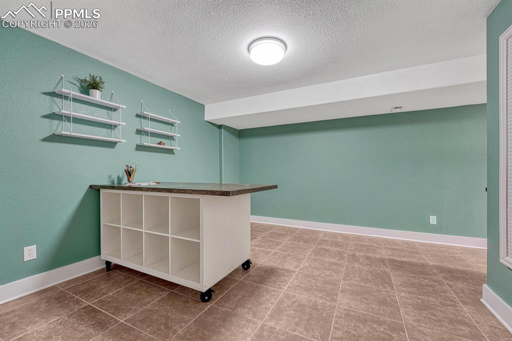 Image 36 of 50: The wet bar features a refrigerator, dishwasher, and microwave.