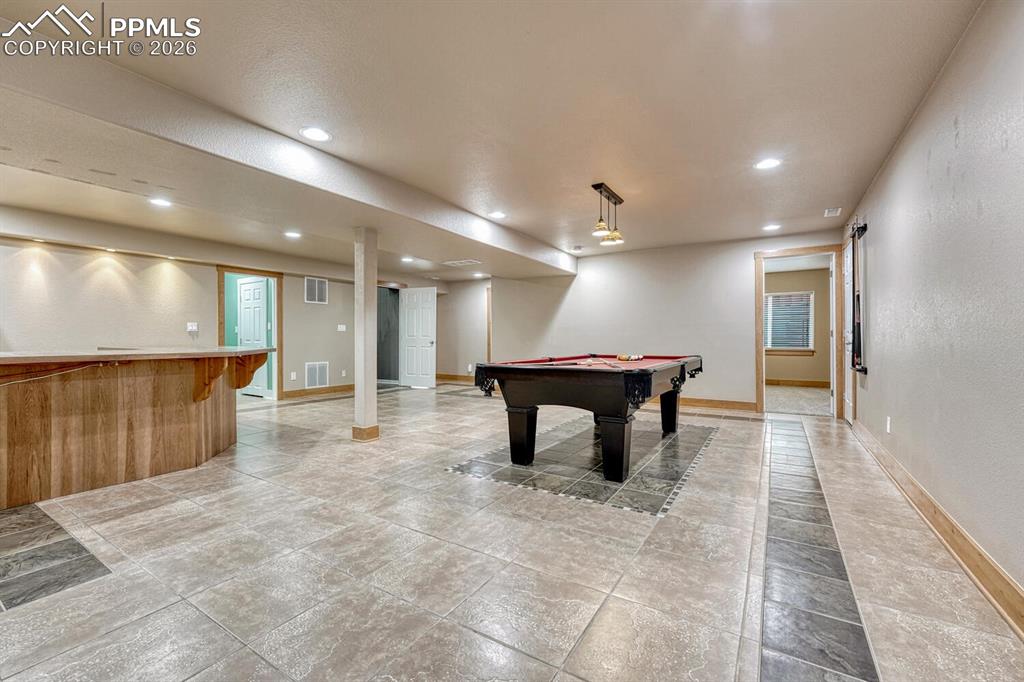 Image 5 of 50: The spacious Great Room is filled with natural light from a wall of windows