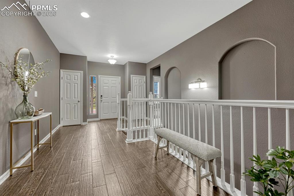 Image 9 of 50: Backyard oasis with mature landscaping, auto sprinklers, a large wood deck,