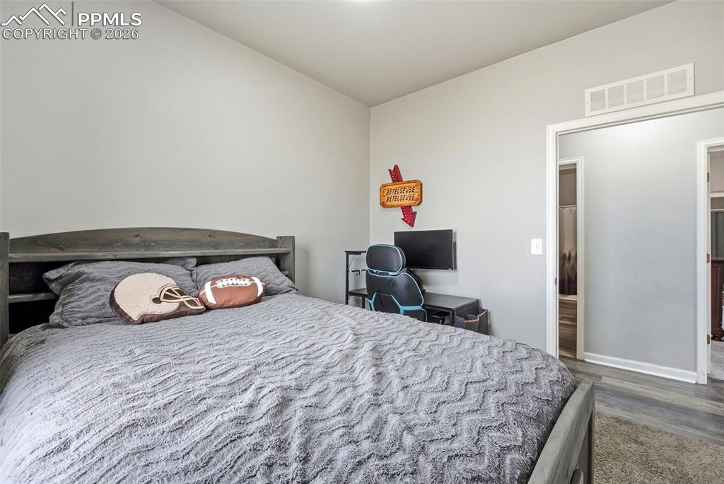 Image 15 of 41: Bedroom featuring dark wood-type flooring and baseboards