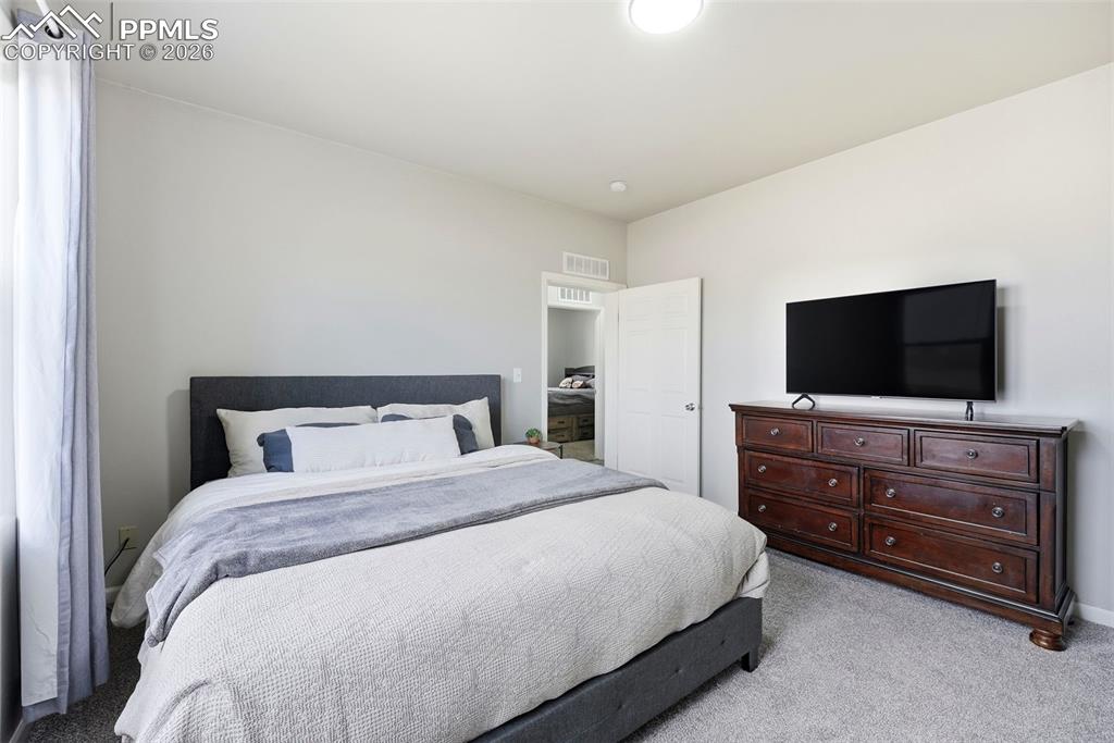 Image 18 of 41: Bedroom featuring light carpet