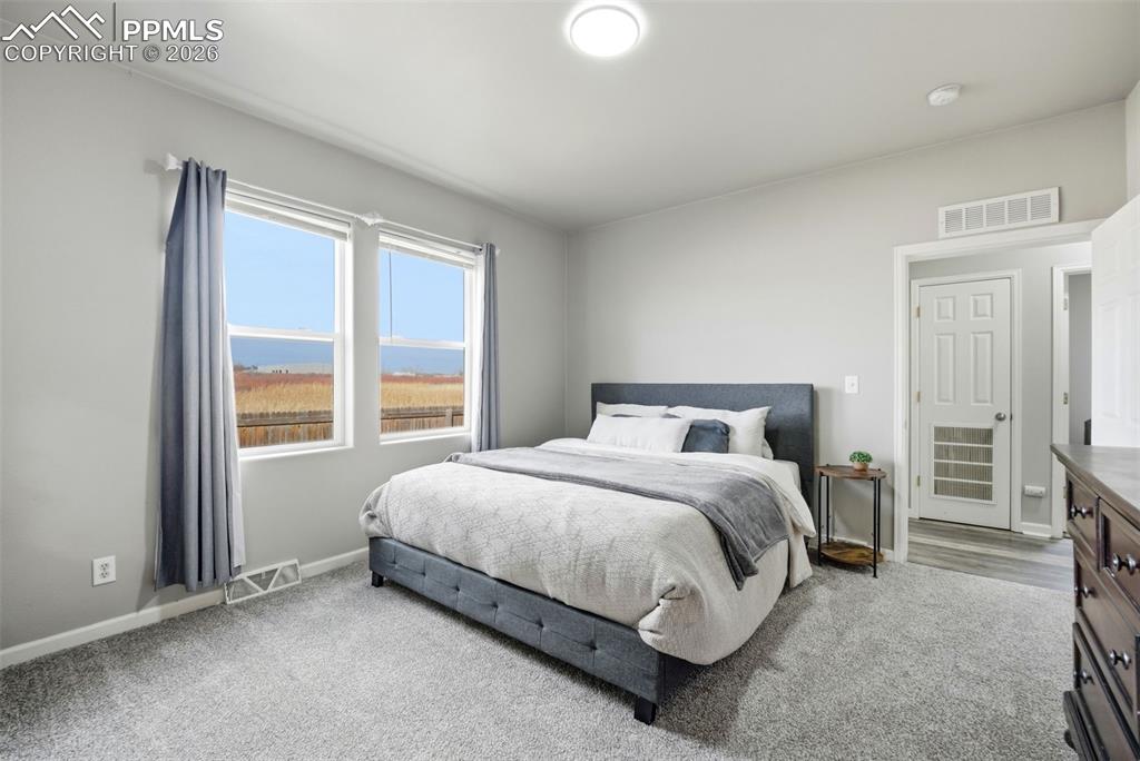 Image 19 of 41: Bedroom with carpet floors and baseboards