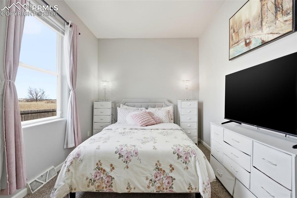 Image 24 of 41: Bedroom with carpet flooring and baseboards