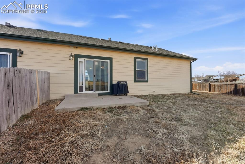 Image 27 of 41: Rear view of property featuring a patio area and a fenced backyard