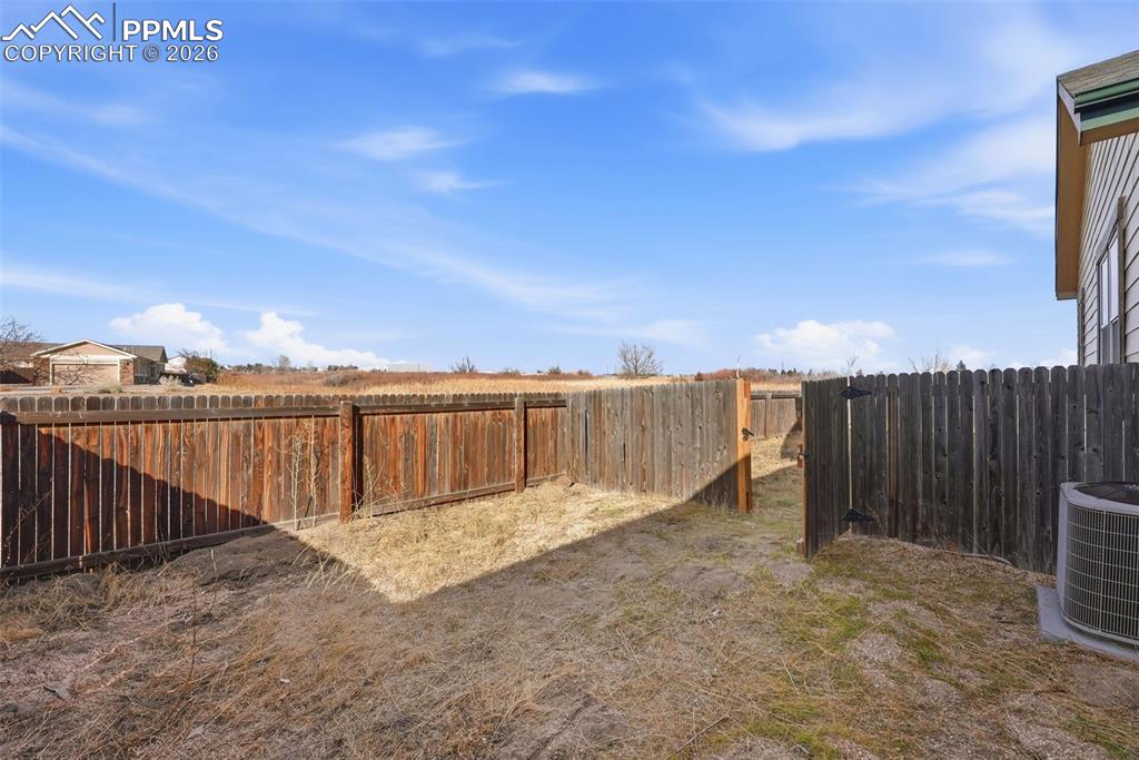 Image 32 of 41: View of fenced backyard