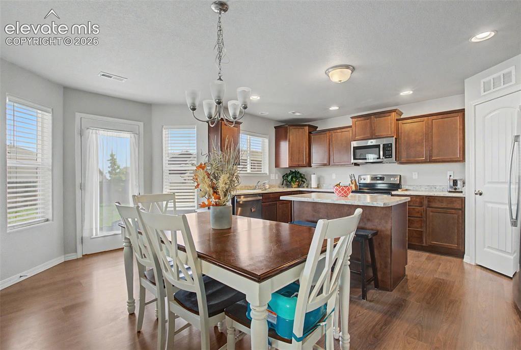 Image 10 of 34: Dining area with walkout to backyard