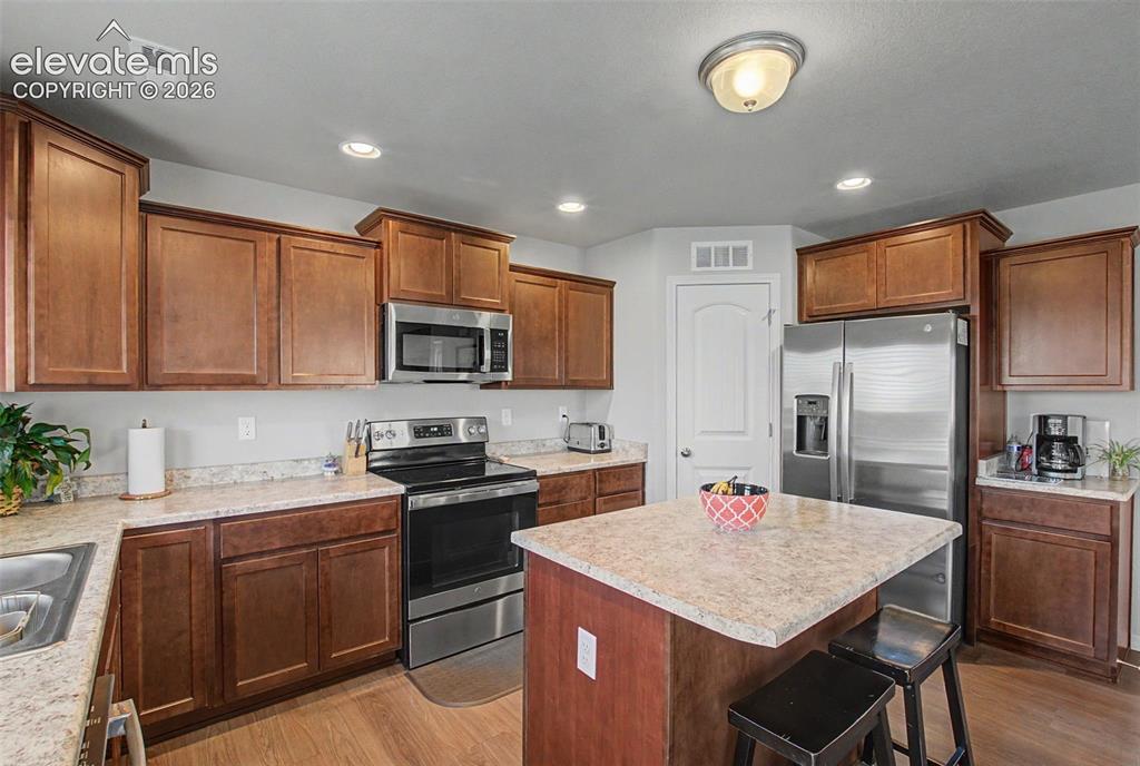 Image 12 of 34: Kitchen with stainless steel appliances and pantry