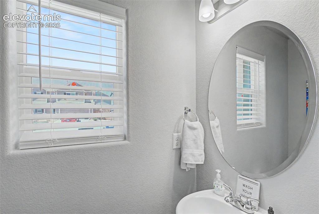 Image 16 of 34: Powder room on main level with window