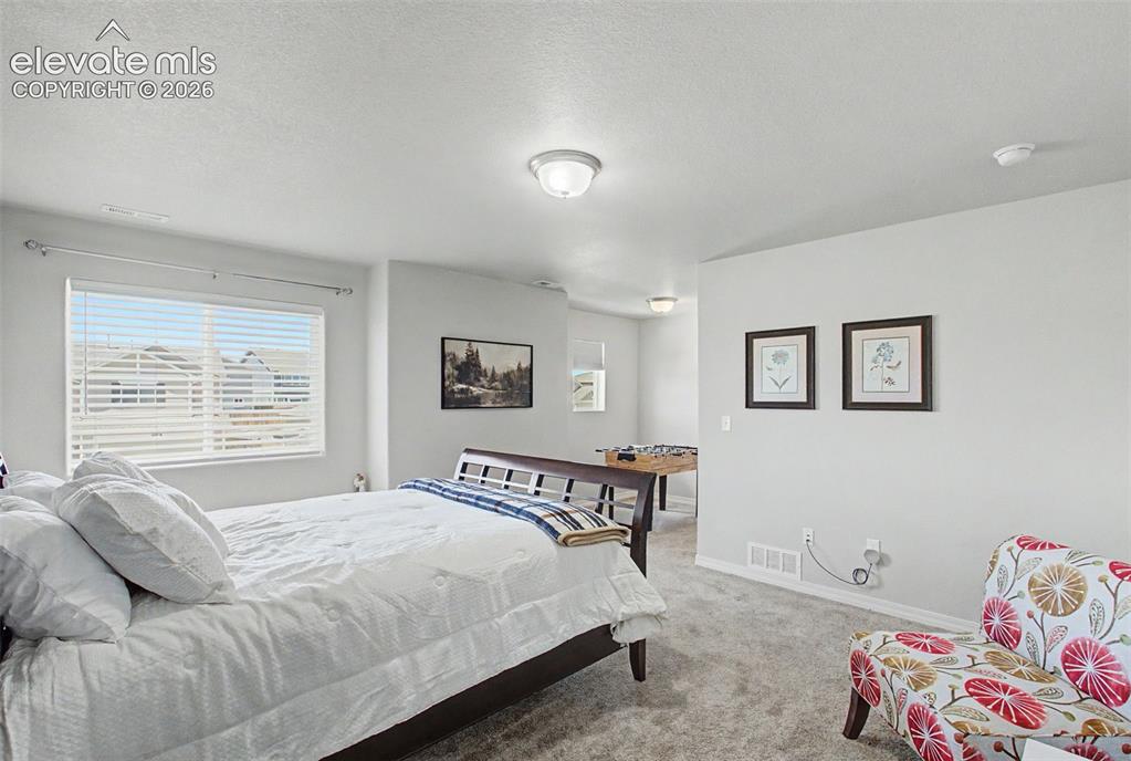 Image 21 of 34: Primary bedroom with view of sitting area