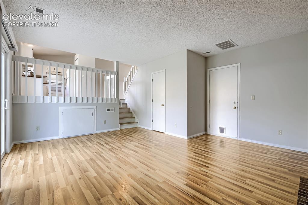 Image 12 of 30: Another view of Family Room. Entrance door to bonus room is below railing.