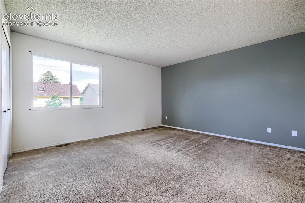 Image 16 of 30: Un-staged. Primary bedroom is 14x14