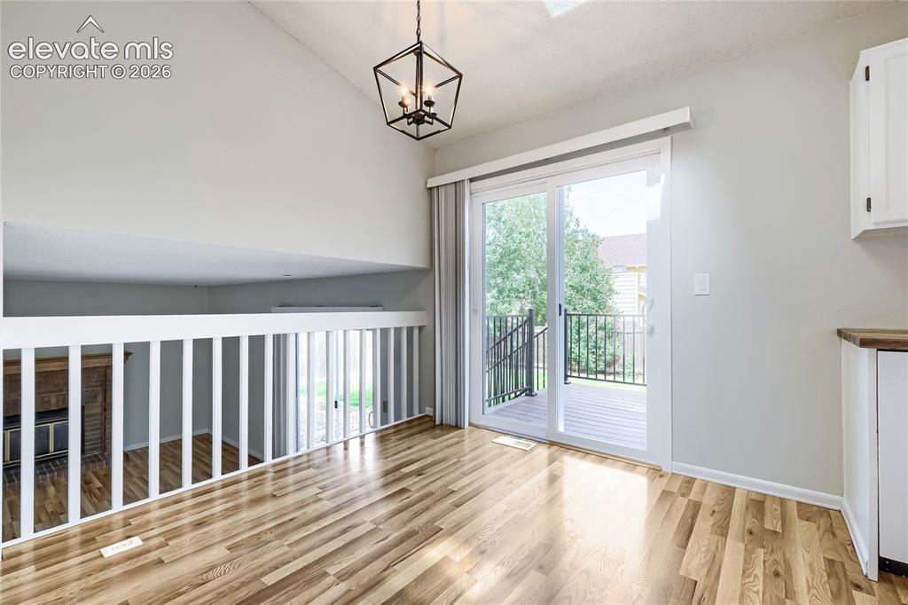 Image 7 of 30: Un-staged. Dining area showing patio door to deck