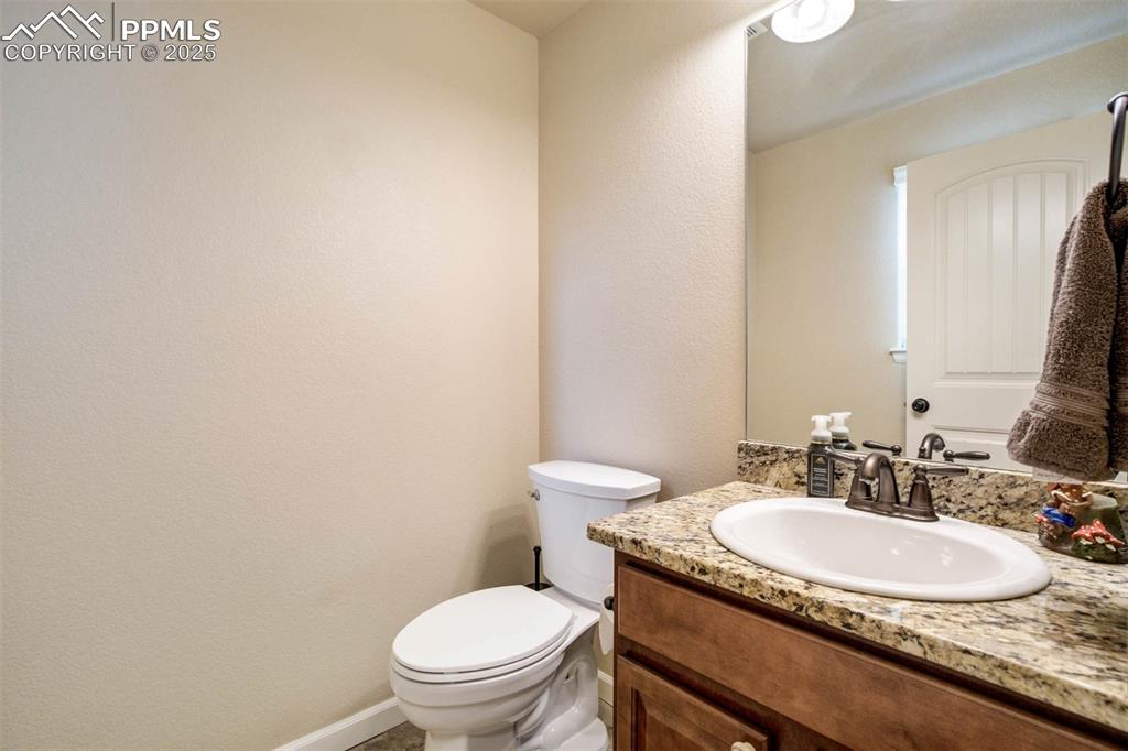 Image 18 of 49: Bathroom with vanity and a textured wall