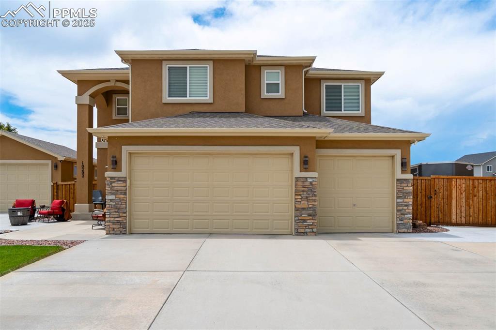 Image 2 of 49: Prairie-style home with an attached garage, stucco siding, driveway, and st