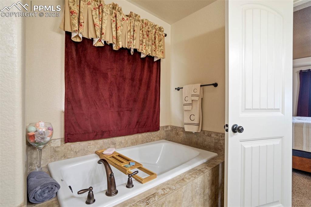 Image 26 of 49: Bathroom with a bath