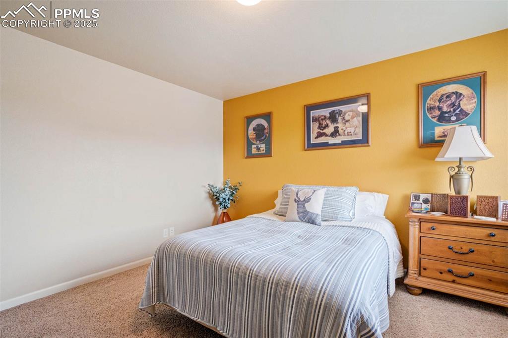 Image 27 of 49: Bedroom featuring carpet and baseboards