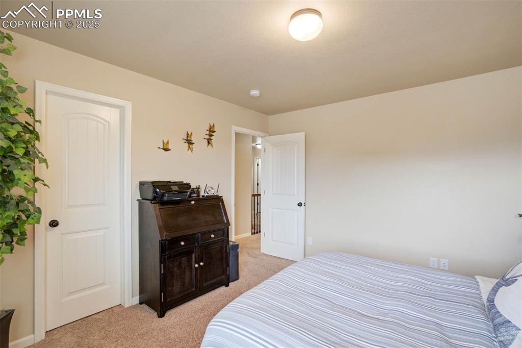 Image 28 of 49: Bedroom with light colored carpet