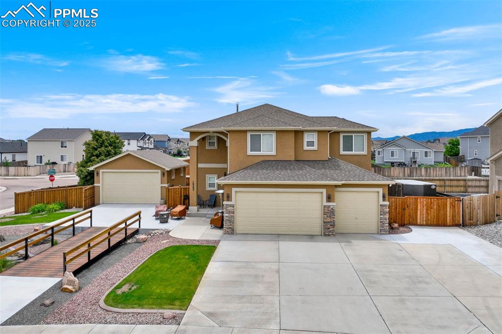 Image 3 of 49: View of front of home with stucco siding, a residential view, concrete driv