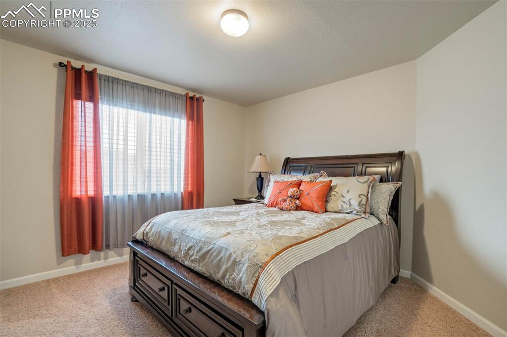 Image 30 of 49: Bedroom featuring light colored carpet and baseboards